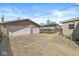 Spacious detached garage featuring three bays, a side door, and an expansive concrete driveway at 103 S Delawanda Ave, Muncie, IN 47303