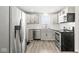 Bright kitchen with stainless steel appliances and lots of cabinets, perfect for cooking and entertaining guests at 103 S Delawanda Ave, Muncie, IN 47303
