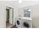Functional laundry room with a washer and dryer, with easy access to a half bathroom at 103 S Delawanda Ave, Muncie, IN 47303