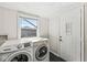 Convenient laundry room with modern appliances and a bright window, making chores a breeze at 103 S Delawanda Ave, Muncie, IN 47303