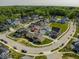 A picturesque aerial view features colorful homes, lush greenery, and paved streets at 10483 St Anne Dr, Zionsville, IN 46077