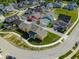 Attractive aerial view of a neighborhood with colorful houses and a curving sidewalk at 10483 St Anne Dr, Zionsville, IN 46077