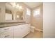 Bathroom featuring a white vanity with dual sinks and a large, well-lit mirror at 10483 St Anne Dr, Zionsville, IN 46077