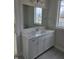 Bathroom vanity featuring modern cabinets and a marble countertop at 10483 St Anne Dr, Zionsville, IN 46077