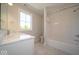 Bright bathroom featuring a tiled shower-tub combo, marble countertop, and neutral color palette at 10483 St Anne Dr, Zionsville, IN 46077