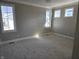 Bright bedroom featuring neutral walls, plush carpeting, and multiple windows for ample natural light at 10483 St Anne Dr, Zionsville, IN 46077