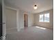 Bright bedroom with carpet, a large window, and access to an ensuite bathroom and walk-in closet at 10483 St Anne Dr, Zionsville, IN 46077