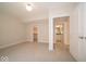 Bright bedroom featuring neutral walls, plush carpeting, two doors, and an open closet at 10483 St Anne Dr, Zionsville, IN 46077