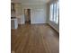 Open concept dining room featuring hardwood floors, large windows, and a view into the kitchen at 10483 St Anne Dr, Zionsville, IN 46077