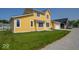 Charming two-story yellow home with a well-manicured lawn and a two-car garage at 10483 St Anne Dr, Zionsville, IN 46077