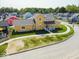 Charming two-story home featuring a landscaped yard and inviting front porch, aerial view at 10483 St Anne Dr, Zionsville, IN 46077