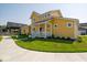 Attractive yellow home with a well-maintained lawn and sidewalk at 10483 St Anne Dr, Zionsville, IN 46077
