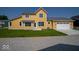 Beautiful yellow two-story home with a two-car garage and well-kept lawn at 10483 St Anne Dr, Zionsville, IN 46077