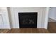Close-up view of a modern fireplace with white brick surround and a decorative mantel in living room at 10483 St Anne Dr, Zionsville, IN 46077