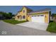 A well-maintained, attached two-car garage and a lush green lawn at 10483 St Anne Dr, Zionsville, IN 46077