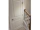Hallway leading to carpeted stairs and a closed door at 10483 St Anne Dr, Zionsville, IN 46077