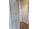 Hallway featuring a tall, gray storage cabinet and a door leading to another room, showcasing the home's layout at 10483 St Anne Dr, Zionsville, IN 46077