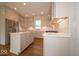 Spacious kitchen featuring stone countertops and custom cabinets at 10483 St Anne Dr, Zionsville, IN 46077