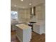 Stylish kitchen showcasing gray cabinets, stainless steel appliances, and a central island with quartz countertop at 10483 St Anne Dr, Zionsville, IN 46077