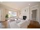 Bright living room with a fireplace, large windows, and modern furniture at 10483 St Anne Dr, Zionsville, IN 46077