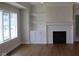 Inviting living room with fireplace, custom built-ins, and large windows providing abundant light at 10483 St Anne Dr, Zionsville, IN 46077