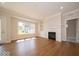 Bright living room featuring a fireplace and large window at 10483 St Anne Dr, Zionsville, IN 46077