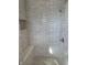 Elegant tiled shower with a built-in bench and a modern showerhead at 10483 St Anne Dr, Zionsville, IN 46077