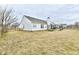 Well-maintained backyard with a white home, green grass, and a trampoline at 1055 Berrywood Dr, Greenwood, IN 46143