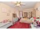 Inviting bedroom featuring a canopy bed, ceiling fan, and a red rug on the floor at 1055 Berrywood Dr, Greenwood, IN 46143