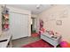 Well-organized bedroom with a closet, wood-look floors, and playful decor at 1055 Berrywood Dr, Greenwood, IN 46143