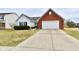 Quaint single-Gathering house with brick and siding, a well-maintained lawn, and a driveway leading to the attached garage at 1055 Berrywood Dr, Greenwood, IN 46143