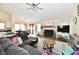 Spacious living room with a fireplace, vaulted ceiling, and plenty of natural light, perfect for relaxation and entertaining at 1055 Berrywood Dr, Greenwood, IN 46143