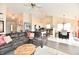 Open-concept living area with gray sectional, vaulted ceilings, and seamless flow to the kitchen at 1055 Berrywood Dr, Greenwood, IN 46143