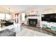 Comfortable living area with fireplace, TV, and seamless flow to the dining space at 1055 Berrywood Dr, Greenwood, IN 46143
