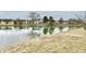 Scenic pond view showcasing neighborhood homes in the background at 1055 Berrywood Dr, Greenwood, IN 46143