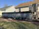 Backyard featuring an above-ground pool with a deck and landscaped area at 1217 Meadowood Dr, Danville, IN 46122