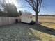 Backyard featuring a small storage shed sitting on a grassy lawn with partial fence at 1217 Meadowood Dr, Danville, IN 46122