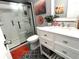 Modern bathroom with updated vanity, framed mirror, glass enclosed shower and patterned floor at 1217 Meadowood Dr, Danville, IN 46122