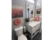 Gray bathroom featuring painted walls, decorative wall art, a modern vanity, and patterned flooring at 1217 Meadowood Dr, Danville, IN 46122