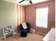 bedroom with a soft color palette, featuring a cozy chair and book storage at 1217 Meadowood Dr, Danville, IN 46122