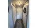 Hallway with wood floors, decorative rug, sliding barn door and a view of the front door at 1217 Meadowood Dr, Danville, IN 46122