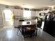 Kitchen featuring white cabinets, black appliances, an island with seating and hard surface floors at 1217 Meadowood Dr, Danville, IN 46122