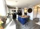 Kitchen featuring white cabinets, black appliances, an island with seating and hard surface floors at 1217 Meadowood Dr, Danville, IN 46122