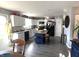 Bright kitchen featuring white cabinets, black appliances, an island with seating and hard surface floors at 1217 Meadowood Dr, Danville, IN 46122