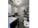 Well-lit laundry room with utility sink, shelving, and washer and dryer hookups at 1217 Meadowood Dr, Danville, IN 46122