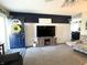 Bright living area with a modern entertainment center and a navy blue accent wall at 1217 Meadowood Dr, Danville, IN 46122
