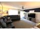 Well-lit living space with a sectional couch, ceiling fan and navy blue accent wall at 1217 Meadowood Dr, Danville, IN 46122