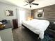 Warm main bedroom featuring a stylish wood accent wall and a comfortable bed at 1217 Meadowood Dr, Danville, IN 46122