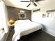 Cozy main bedroom featuring a wood accent wall, ceiling fan, and closet at 1217 Meadowood Dr, Danville, IN 46122