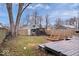 Fenced backyard with wooden deck, storage shed, and garden boxes at 1224 N Olney St, Indianapolis, IN 46201